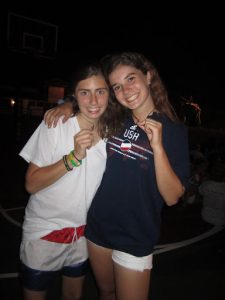 Eliza Kagan as a Bunk One Camper at Lake Bryn Mawr Camp, showing off her angel necklace with a bunkmate