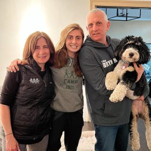 Photo of summer camp directors Jane, Eliza and Dan Kagan with their dog Bryn.